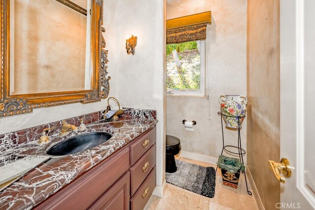 bathroom with tile patterned floors, toilet, and vanity