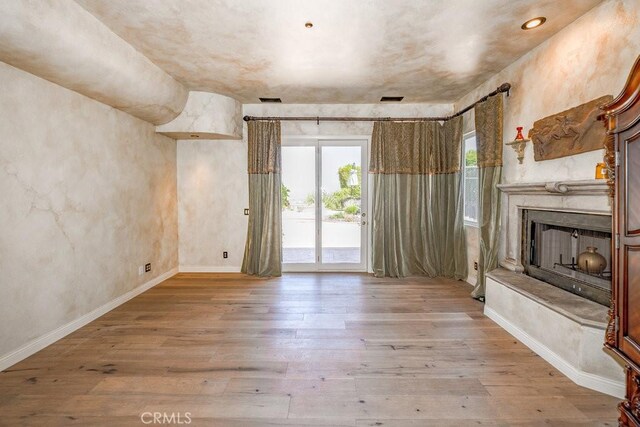 unfurnished living room with hardwood / wood-style flooring