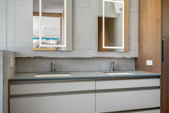 kitchen with sink, decorative backsplash, and white cabinets