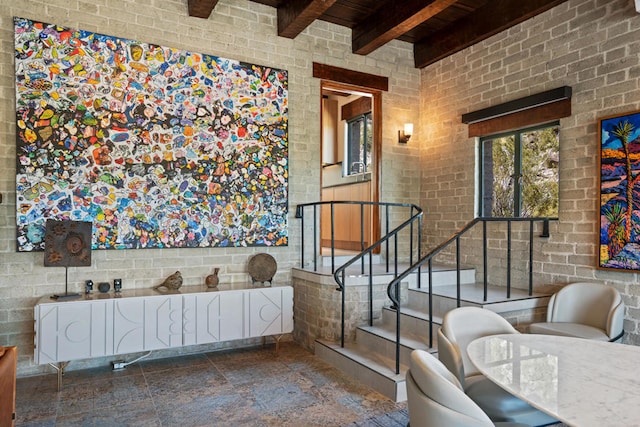 bathroom featuring beamed ceiling, brick wall, and tile patterned flooring