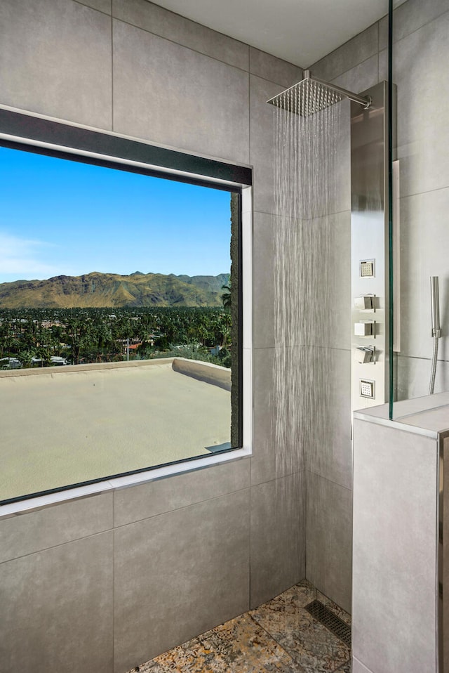 bathroom with a mountain view and tiled shower