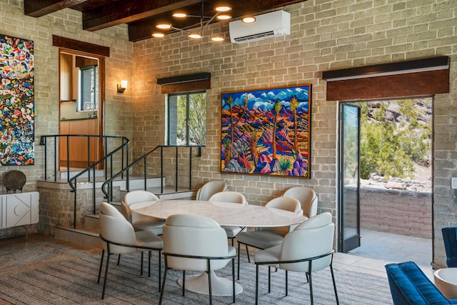 dining room featuring brick wall, an AC wall unit, and beam ceiling