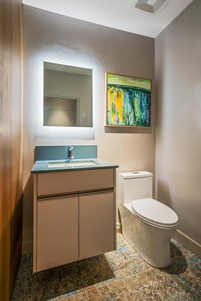 bathroom with tile patterned flooring, vanity, and toilet