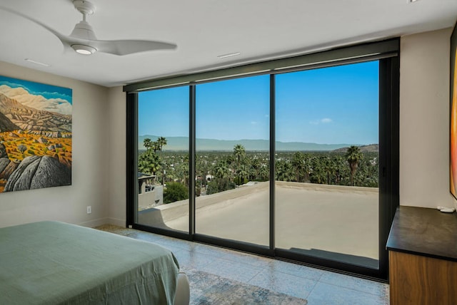 tiled bedroom featuring ceiling fan and floor to ceiling windows