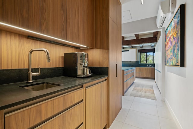 kitchen featuring sink, light tile patterned flooring, and a wall unit AC