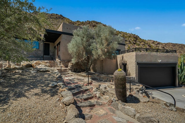 view of home's exterior with a garage and a mountain view