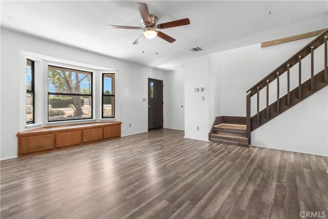 unfurnished living room with ceiling fan and wood-type flooring