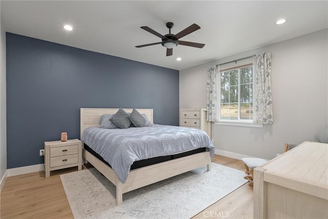 bedroom with ceiling fan and light hardwood / wood-style floors