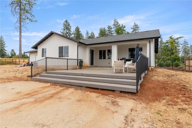 back of house featuring a deck