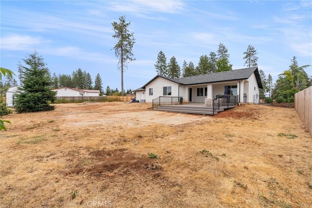 rear view of property with a wooden deck