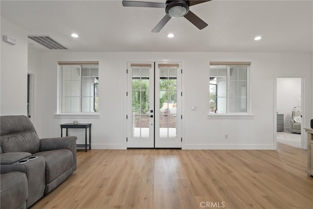 living room with ceiling fan, french doors, and light hardwood / wood-style flooring