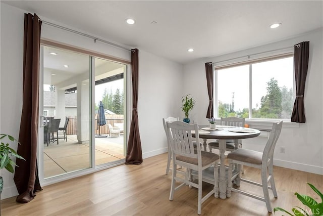 dining area featuring a wealth of natural light and light hardwood / wood-style flooring