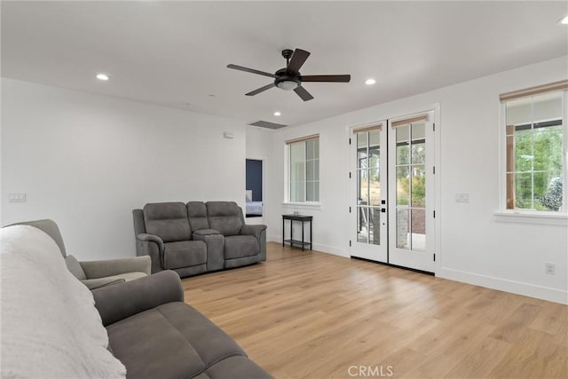 living room featuring ceiling fan and light wood-type flooring