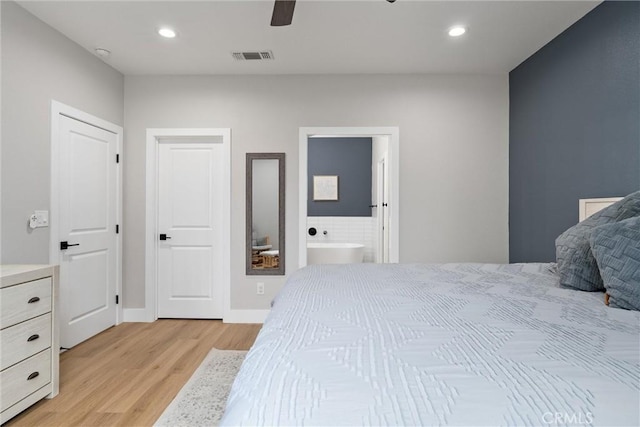 bedroom featuring ensuite bath, ceiling fan, and light wood-type flooring