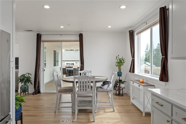 dining area featuring light wood-type flooring