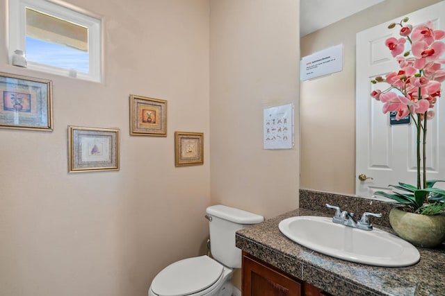 bathroom featuring toilet and vanity