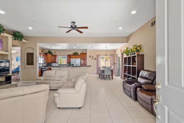 tiled living room featuring ceiling fan