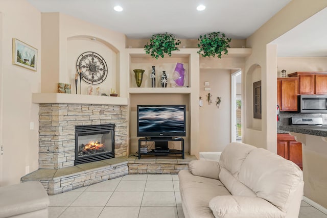 tiled living room featuring a fireplace and built in shelves