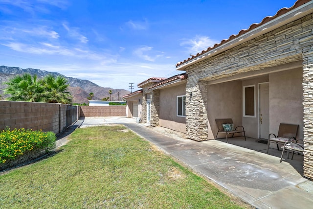 view of yard with a mountain view and a patio