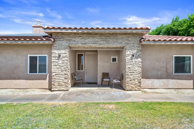 back of house with a patio area and a yard