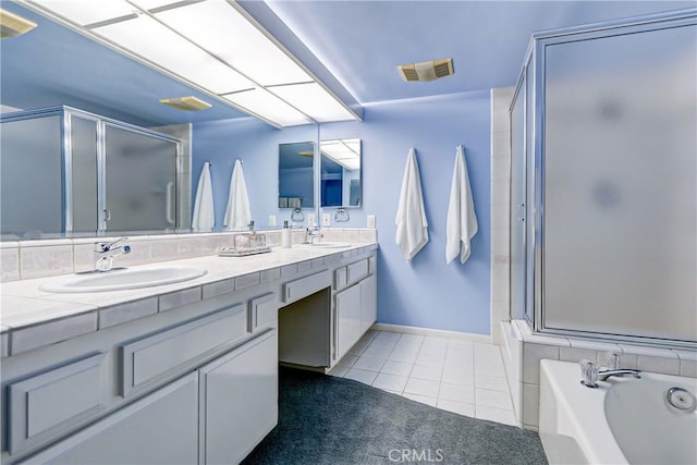 bathroom featuring vanity, tile patterned flooring, and plus walk in shower