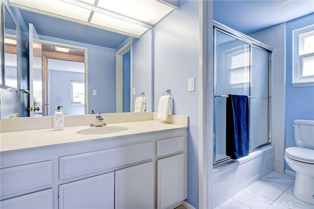 full bathroom with toilet, enclosed tub / shower combo, and vanity