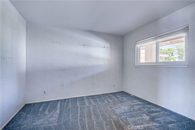 empty room featuring dark carpet