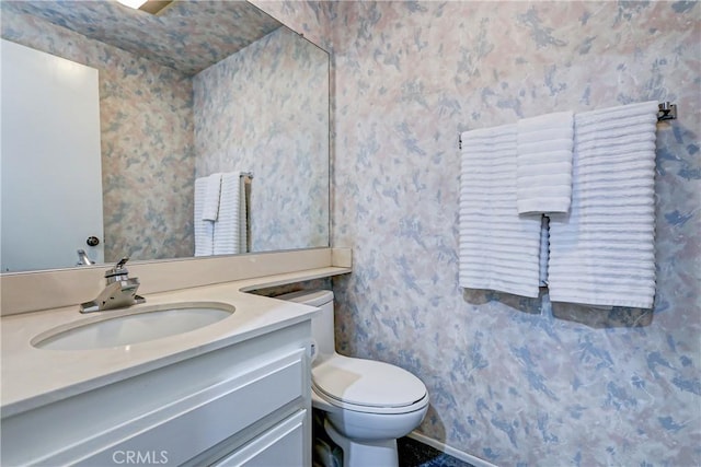 bathroom featuring toilet and vanity