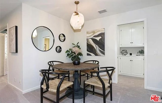 dining room with light carpet