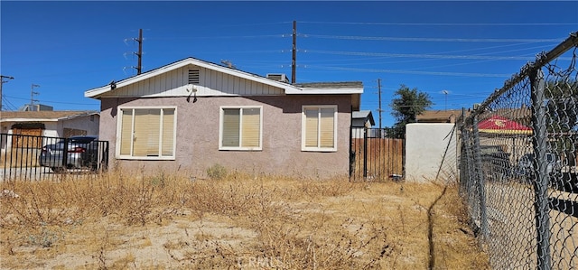 view of property exterior with fence and stucco siding