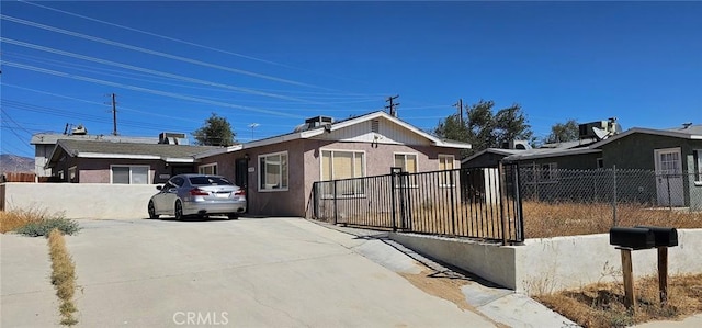 view of front of house featuring fence and stucco siding