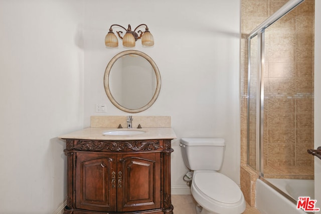 full bathroom with vanity, toilet, tile patterned floors, and bath / shower combo with glass door