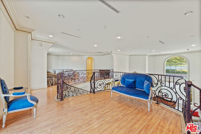 sitting room featuring light hardwood / wood-style floors and crown molding