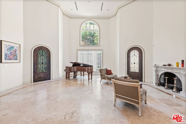 entrance foyer with crown molding and a high ceiling