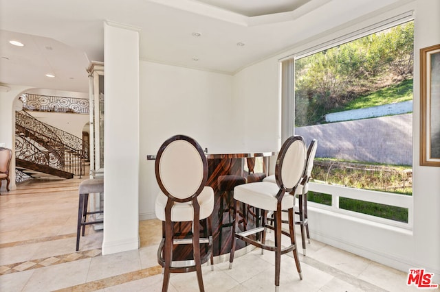 tiled dining space with a wealth of natural light