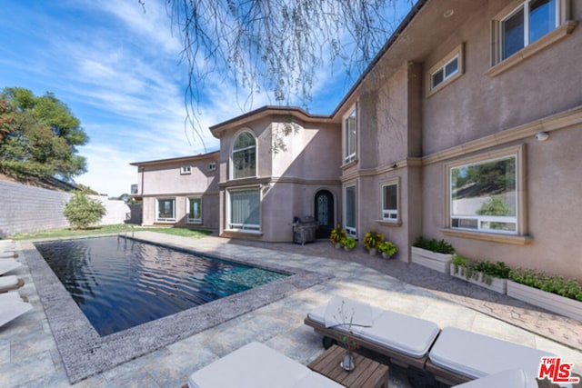 view of swimming pool featuring a patio area