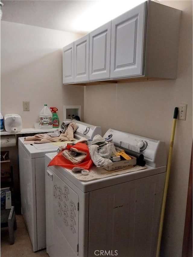 washroom featuring cabinets and separate washer and dryer