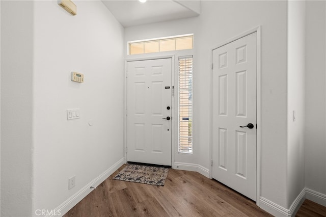 entrance foyer featuring light wood-style floors and baseboards