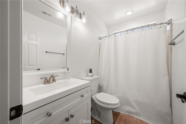 full bath featuring visible vents, toilet, vanity, wood finished floors, and a shower with curtain