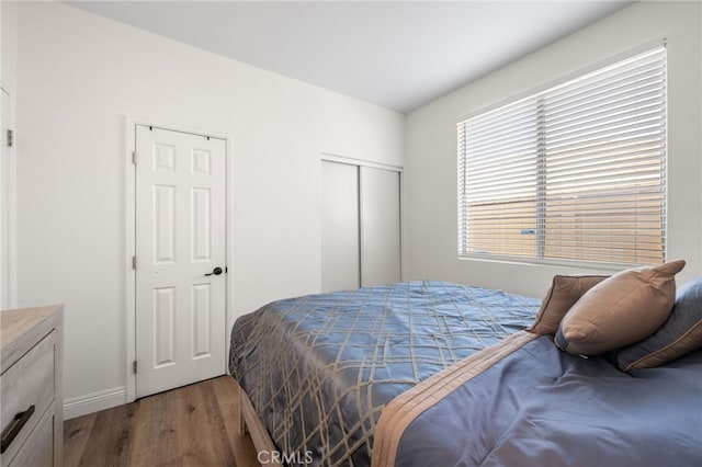 bedroom with a closet and wood finished floors