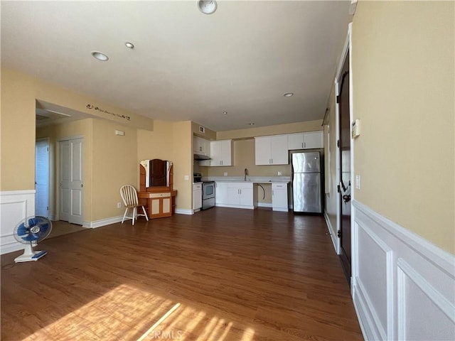 unfurnished living room featuring dark hardwood / wood-style floors and sink