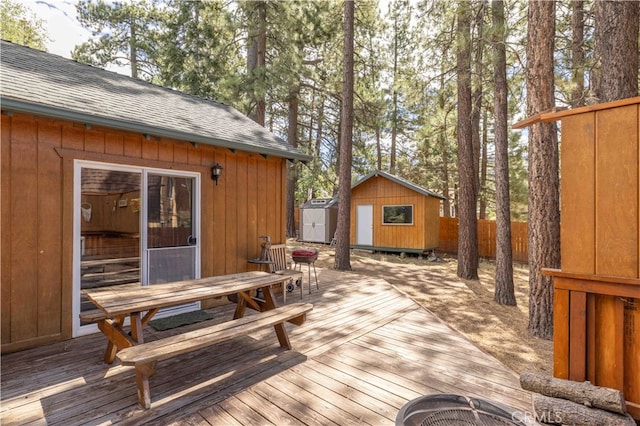 wooden terrace with a storage shed