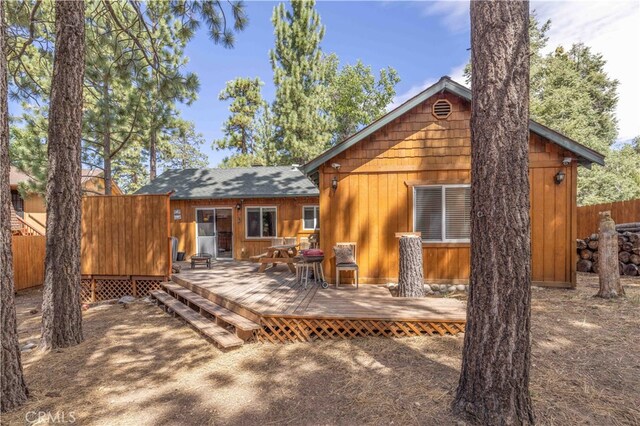 back of house featuring a deck