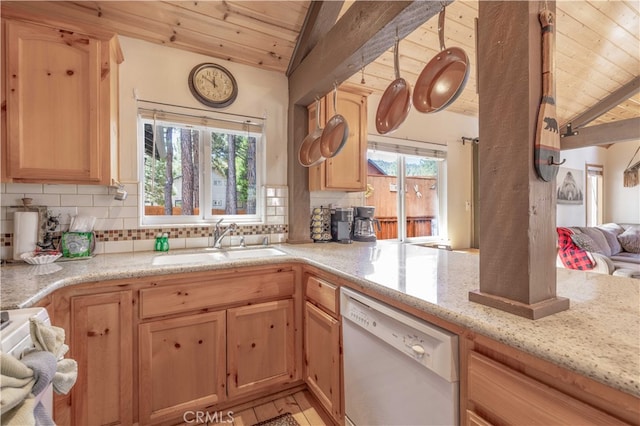 kitchen with lofted ceiling, stove, sink, and white dishwasher