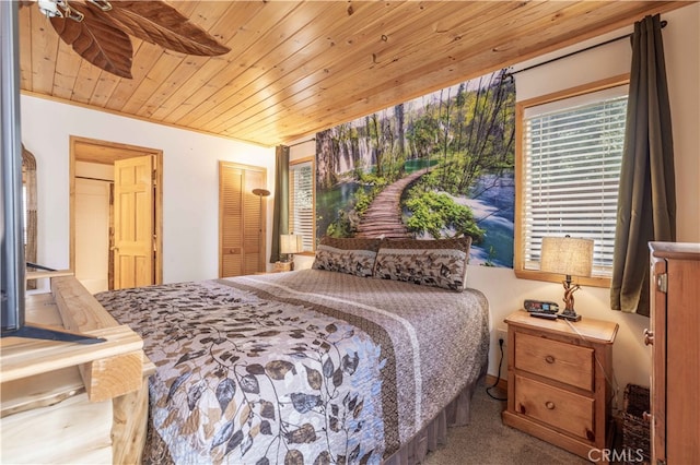 bedroom featuring wooden ceiling, carpet flooring, and ceiling fan