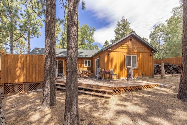 back of property featuring a wooden deck