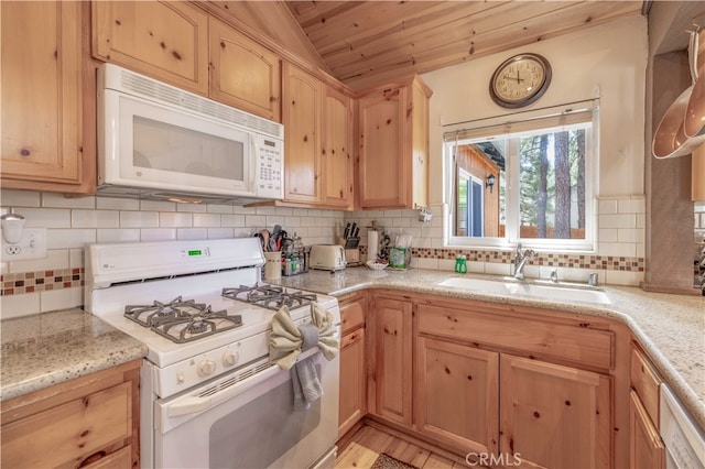 kitchen with decorative backsplash, white appliances, lofted ceiling, light hardwood / wood-style flooring, and sink