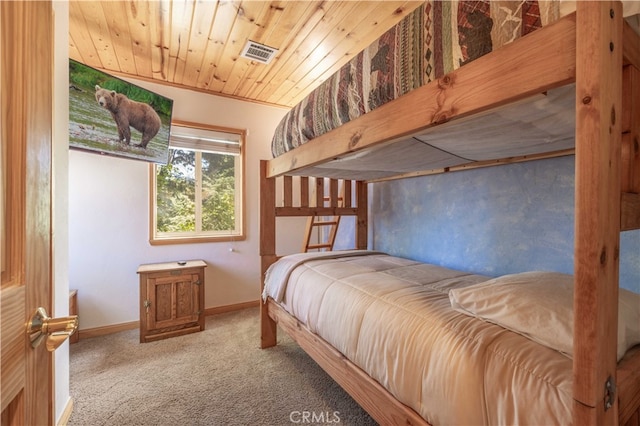 bedroom featuring wooden ceiling, carpet flooring, and ornamental molding