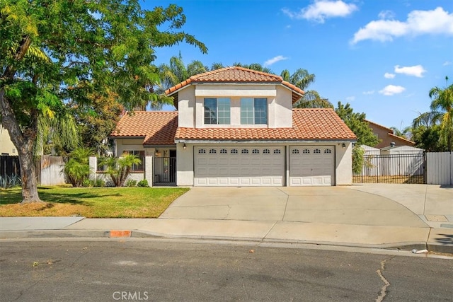 mediterranean / spanish-style home with a garage and a front lawn