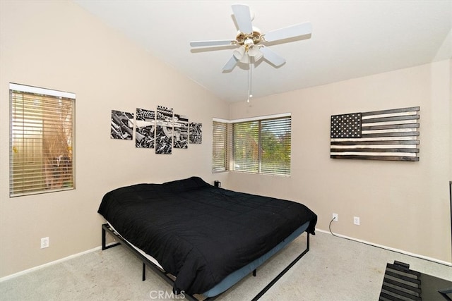 carpeted bedroom featuring lofted ceiling and ceiling fan